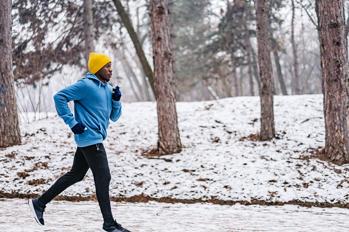 man running snow trees