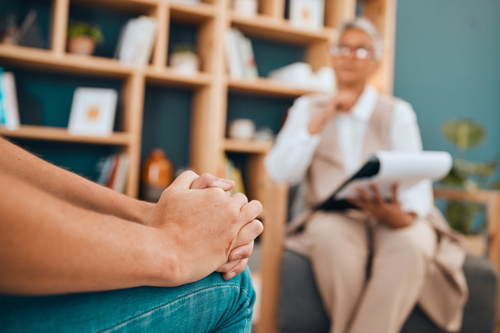 mature couselor hands folded therapy