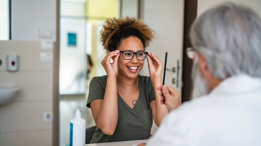 woman trying on glasses with dr